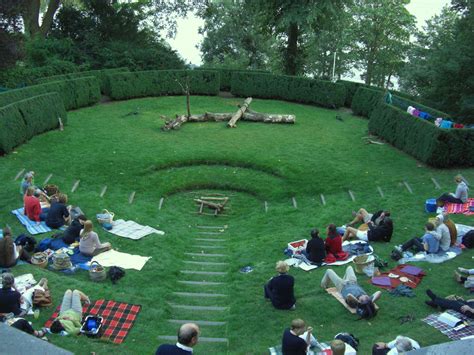 People Are Sitting In The Middle Of A Circular Lawn