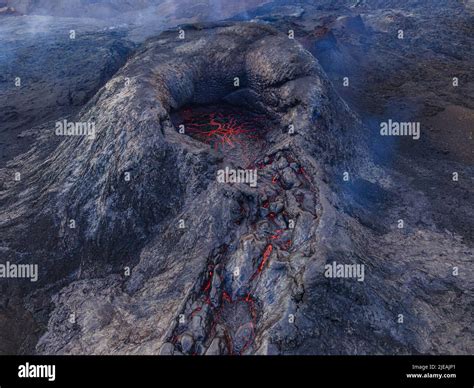 Volcano crater from above. View of the structures of red lava in the ...