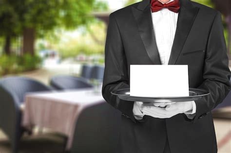 Premium Photo Waiter Or Butler Wearing A Tuxedo Holding A Note Card