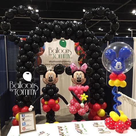 Mickey And Minnie Mouse Sculptures And A Giant Mouse Ear Balloon Arch