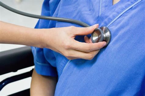 Premium Photo Cropped Hand Of Doctor Examining Patient In Hospital