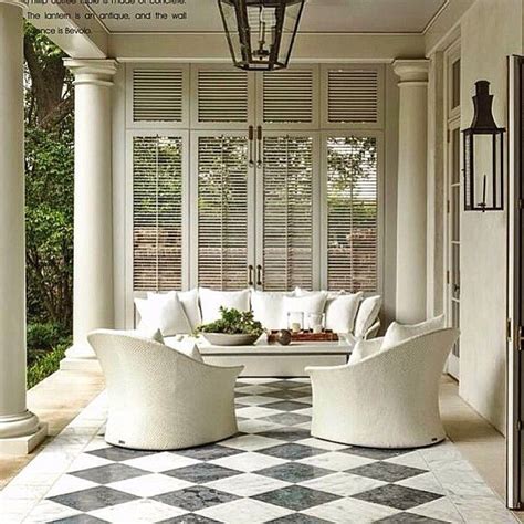 A Living Room Filled With White Furniture And Windows