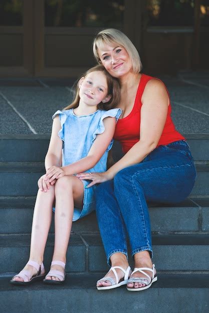 Premium Photo Beautiful Blonde Mom In A Red T Shirt With Her Daughter