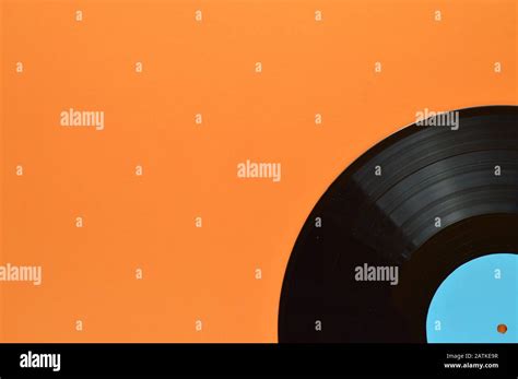 One Old Black Vinyl Record With Blank Cyan Label On The Edge Of Orange