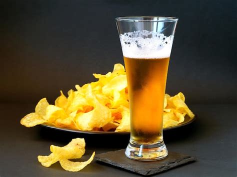 Premium Photo | Glass of beer and chips