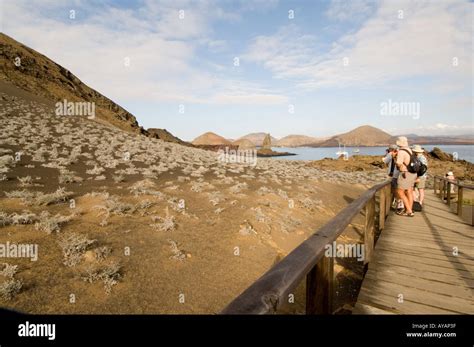 Tourists On The Wooden Walkway On Bartolome Island Pinnacle Rock In