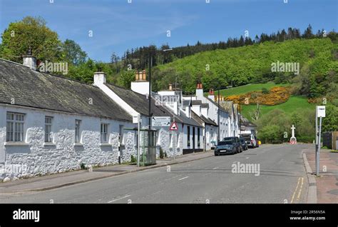 White Washed Buildings In High Street With War Memorial At The End