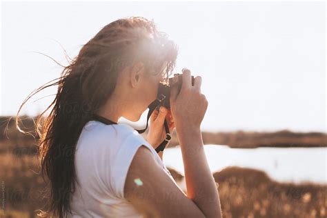 Female Photographer Taking Pictures With Her Camera By Stocksy