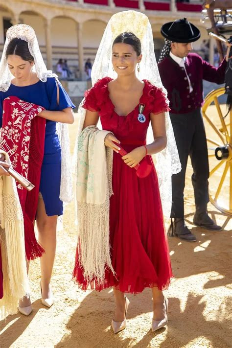 Two Women Dressed In Traditional Mexican Garb And Veils