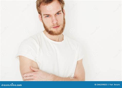 Casually Confident Portrait Of A Confident Young Man Wearing A White T