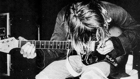 Black And White Photograph Of A Man Playing An Electric Guitar With