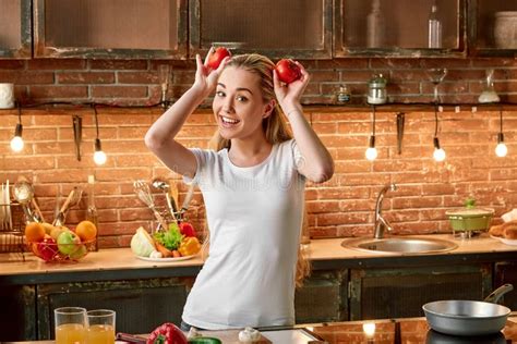 Eat Healthy, Stay Healthy. Happy Young Woman Cooking Vegetables in Modern Kitchen. Cozy Interior ...