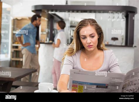 Pretty Blonde Reading The Newspaper Stock Photo Alamy