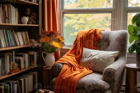 A reading nook complete with an armchair, blanket and a bookshelves ...