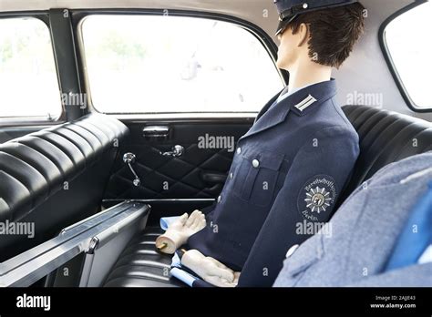 Vintage German police car interior with a dummy dressed in old uniform ...