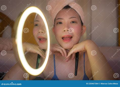 Lifestyle Portrait Of Young Beautiful And Happy Asian Woman Applying