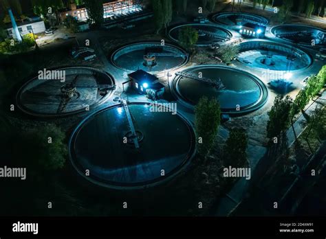 Aerial Night View Of Modern Wastewater Treatment Plant With Round Pools