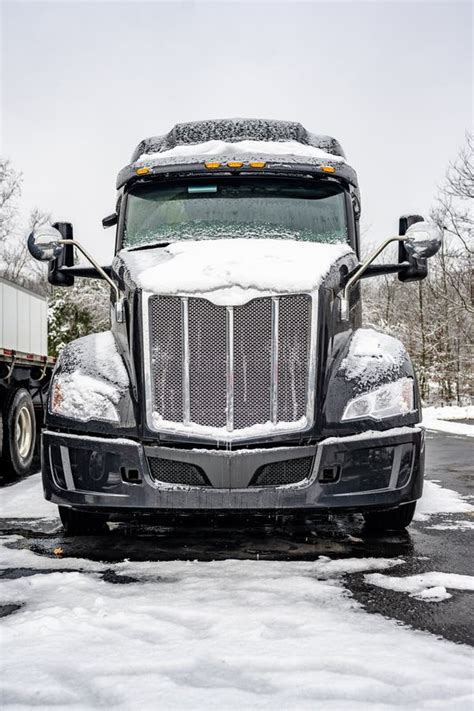 Black Industrial Big Rig Semi Truck With Semi Trailer Standing For The