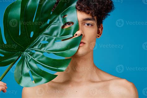 Handsome Man With Curly Hair Naked Shoulders Green Leaf Clear Skin