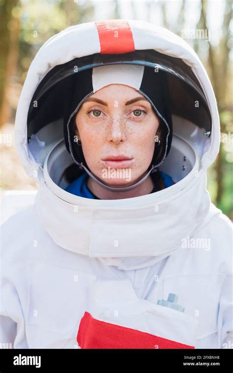 Female astronaut wearing space helmet and suit in forest Stock Photo ...