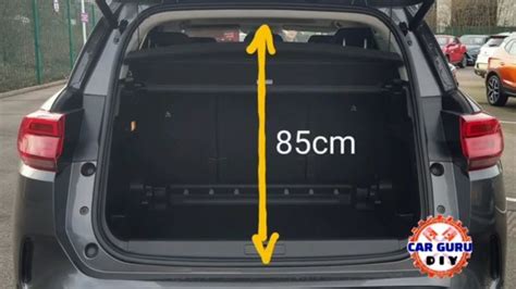 The Back End Of A Car With Its Trunk Open And Yellow Arrow Pointing To