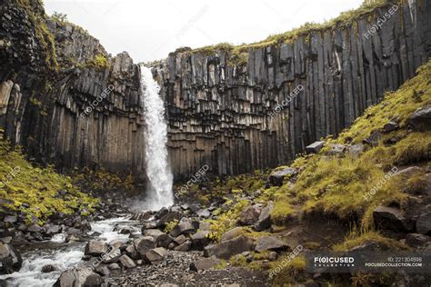 Picturesque waterfall splashing from rocky cliff, Iceland — adventure ...