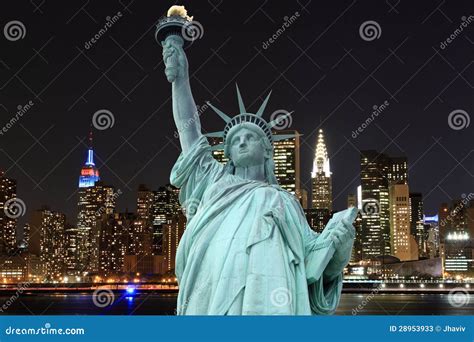 Manhattan Skyline and the Statue of Liberty at Night Stock Image ...