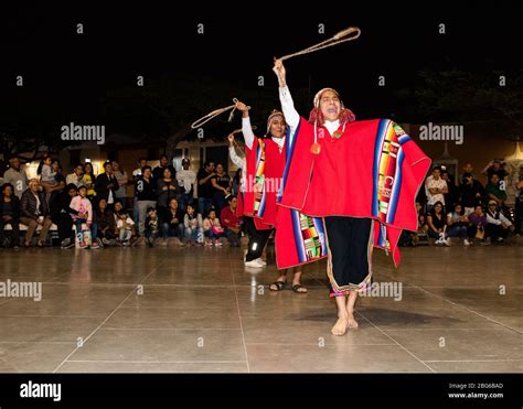 Dancers in colourful costumes performing traditional Huayno Cusqueño Peruvian dance to crowds in ...