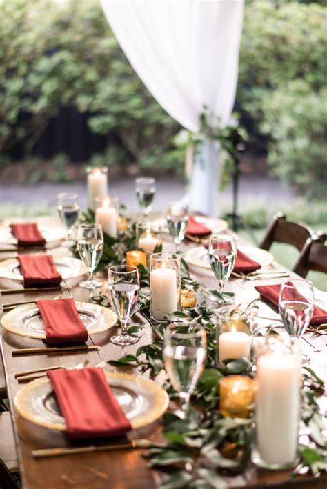 Rectangle Farm Table With Variating Heights Of White Pillar Candles