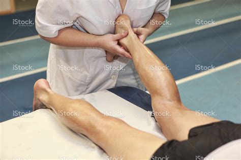 stock-photo-39720180-masseuse-massaging-athlete-s-achilles-tendon-after ...