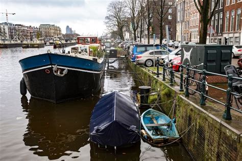 Premium Photo A Boat Is Docked In A Canal In Amsterdam