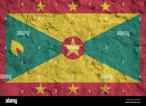 Grenada Flag Depicted In Bright Paint Colors On Old Relief Plastering