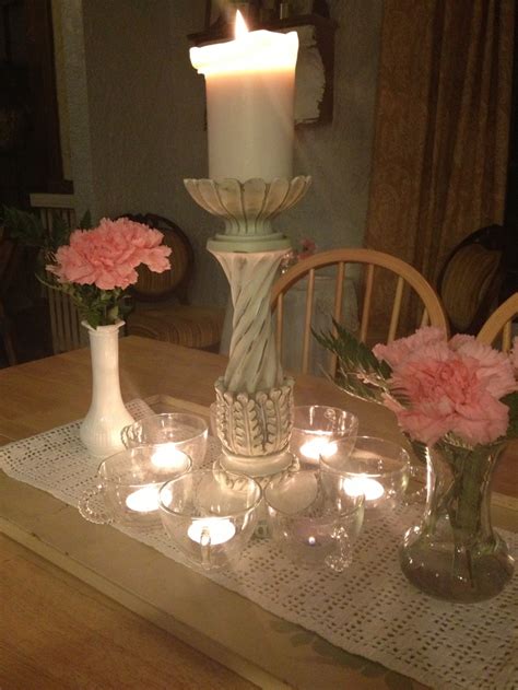 A Table Topped With Vases Filled With Flowers And Candles