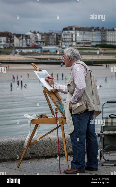 Künstler mit einer Staffelei malen ein Bild von einer Szene am Strand