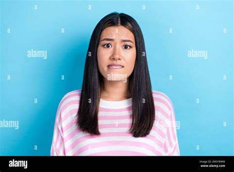 Photo Of Doubtful Unsure Young Lady Wear Striped Sweater Biting Lip