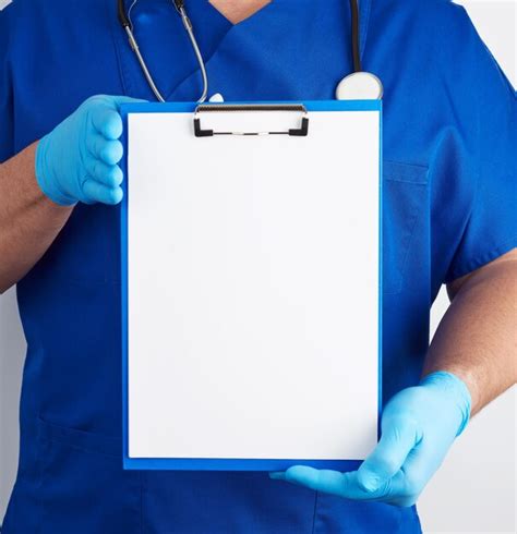 Premium Photo Midsection Of Doctor Holding Clipboard