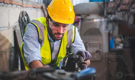 Portrait of Heavy industry workers working on the metal fabrication process by operating a lathe ...