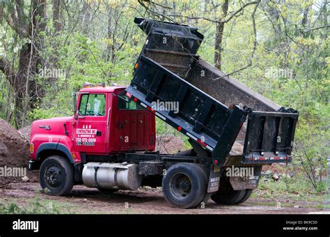 A red dump truck lorry with parked at a construction site with the dump ...