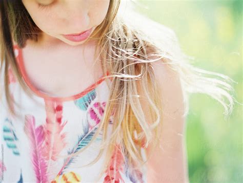 Girl Walking And Enjoying A Field Of Yellow Wildflowers In Summer