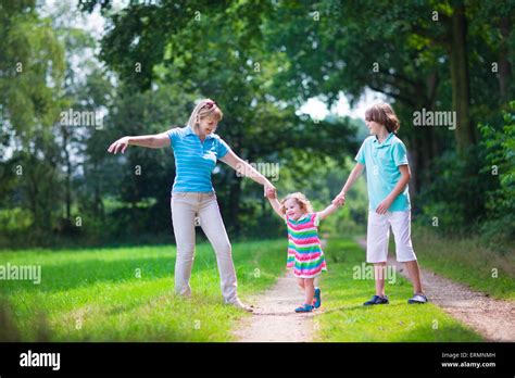 Happy Active Woman Enjoying Hiking With Two Children School Age Boy