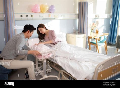 Parents with newborn baby in hospital ward Stock Photo - Alamy