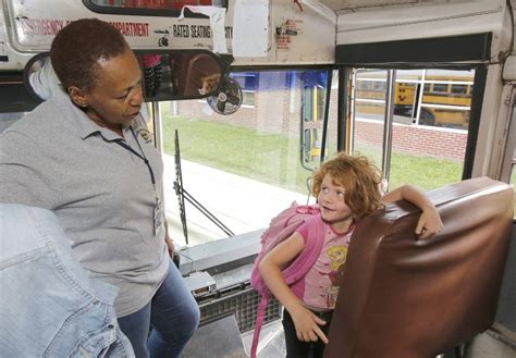 Bus driver Pearlie Able talks to Autumn Burch as she gets on the bus at ...