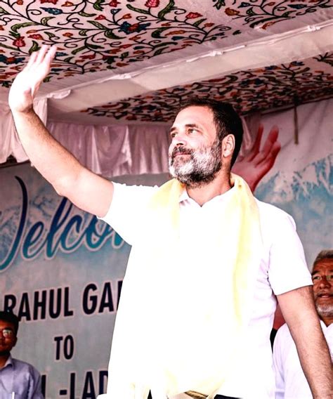 Congress leader Rahul Gandhi waves at supporters during a public meeting