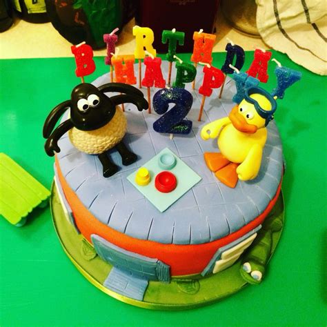 a birthday cake decorated with cartoon characters and candles