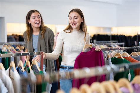 Two Happy Female Friends Are Shopping In Clothing Store Shopping Young