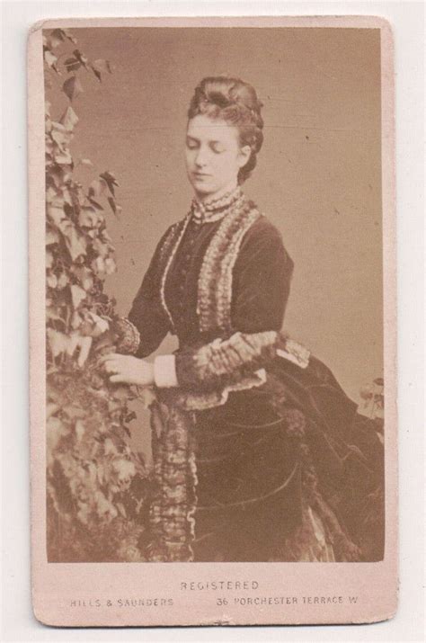 An Old Photo Of A Woman In Dress