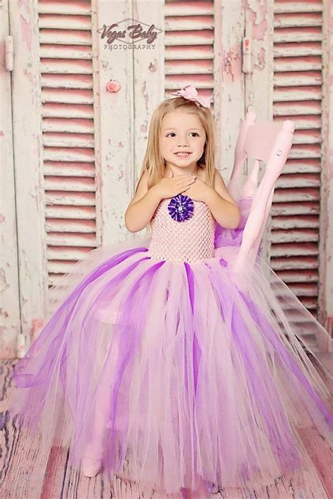 Cute Adorable Girl Baby Is Looking Up Wearing Purple Dress