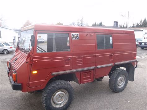 An Old Red Truck Parked In A Parking Lot