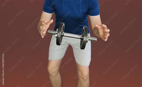 Dumbbell Hanging In The Air Between The Hands Of A Sports Guy