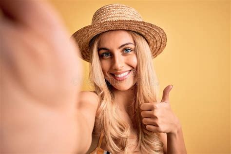 Young Beautiful Blonde Woman On Vacation Wearing Bikini And Hat Making